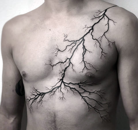 Tattoo lightning on shoulder, chest and abdomen
