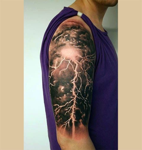 Tattoo lightning on the shoulder of a man