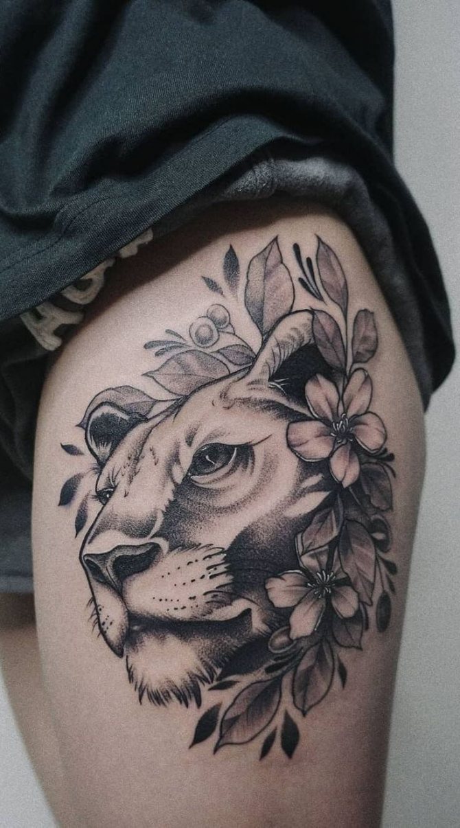 Tattoo on the thigh lioness