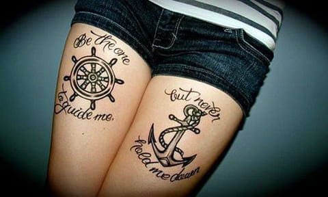 Anchor tattoo on girls thighs with a sea theme