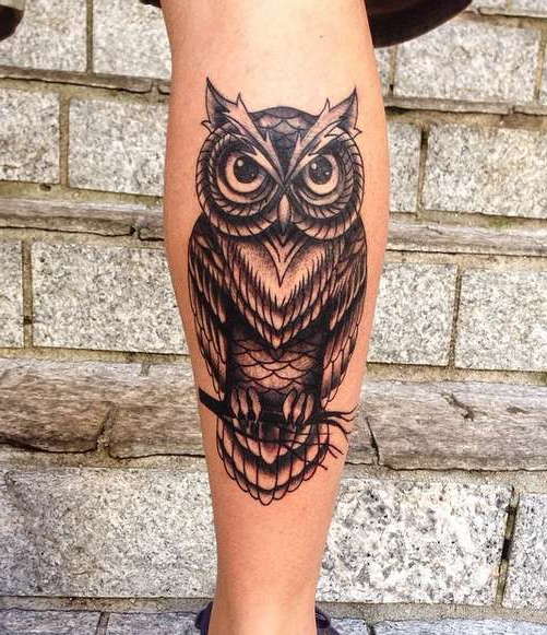 Tattoo of an owl on his leg
