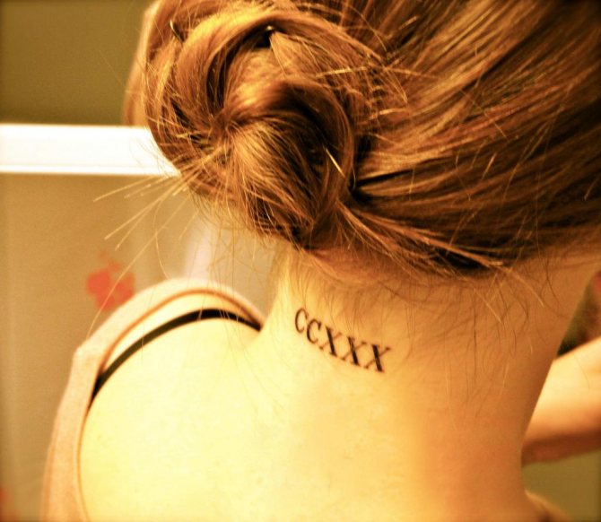 Tattoo inscription. Letters on the back of the neck.