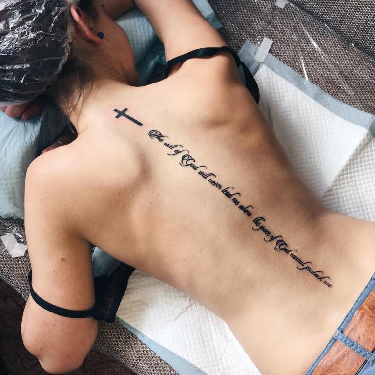 Tattoo inscription on back of girl