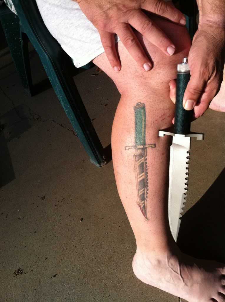 Tattoo of the knife on his leg