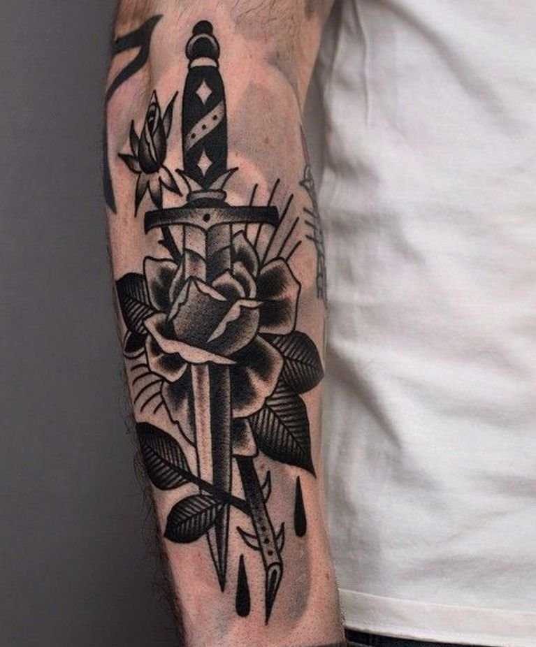 Tattoo of a knife with a rose