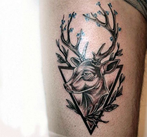Tattoo of deer in a triangle on legs