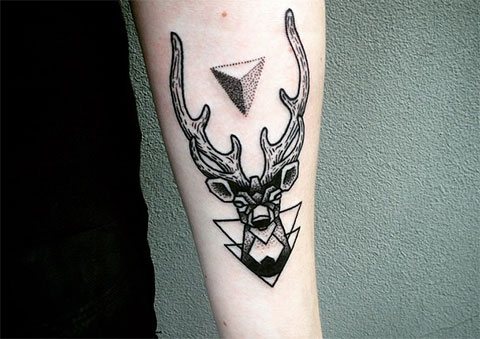 Tattoo deer in a triangle on the arm
