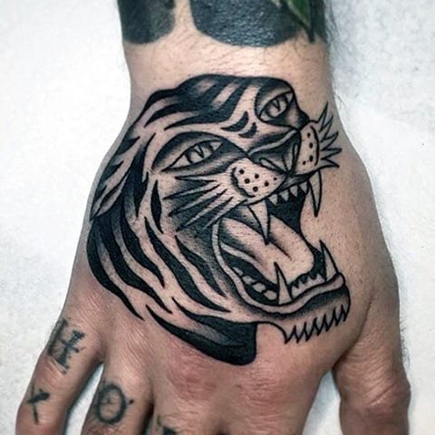 Tattoo of a tiger grinning on hands