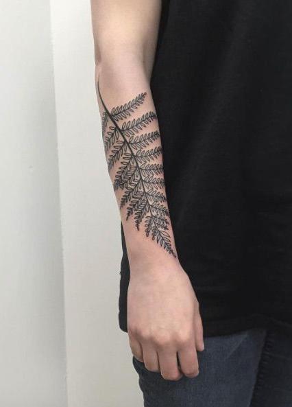 tattoo of a fern on his arm
