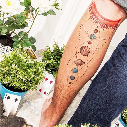 Tattoo parade of planets on my leg