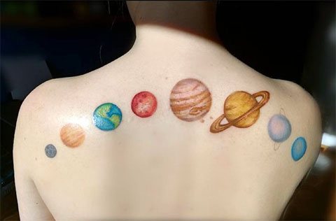 Tattoo parade of planets on the girl's back - photo