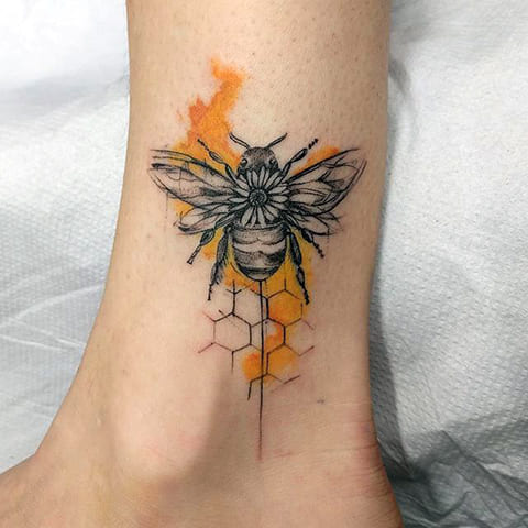 Tattoo of a bee on his leg