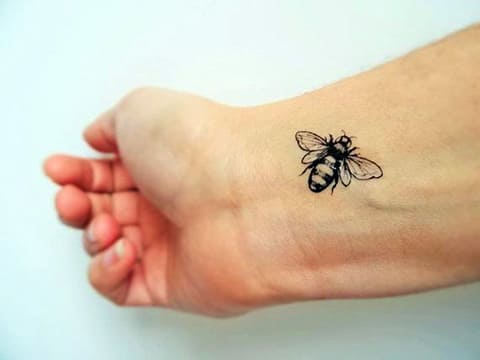 Tattoo of bee on wrist - photo