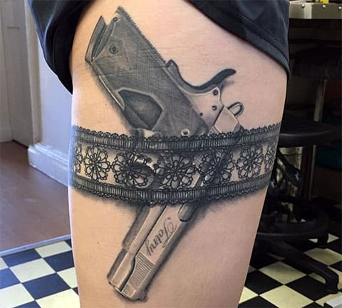 Tattoo gun on hip in garter on a girl