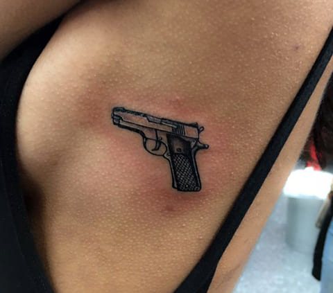 Tattoo a gun on the side of a girl