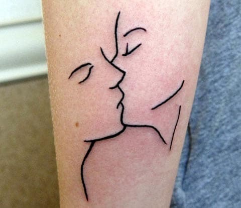 Kiss tattoo on the arm - photo