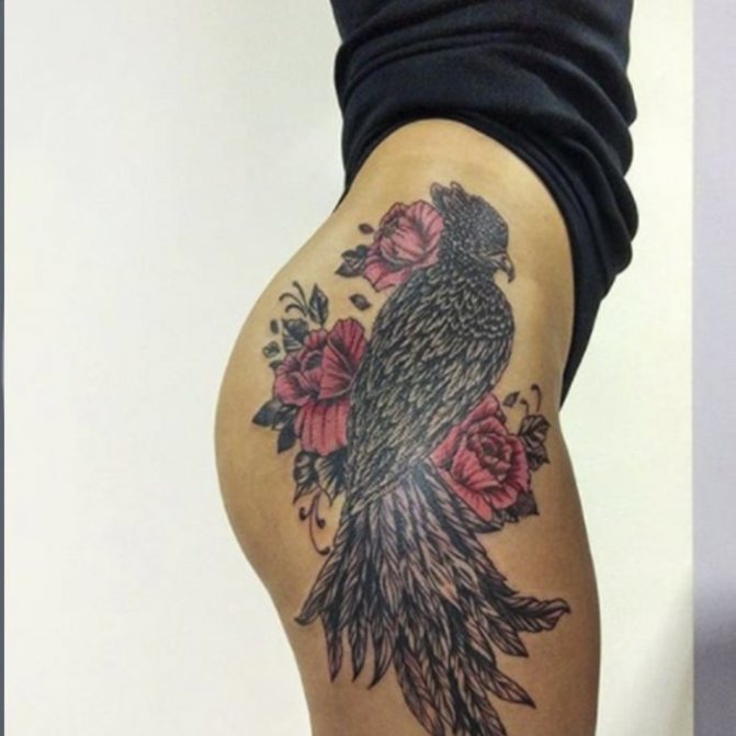 tattooed bird in flowers on the side