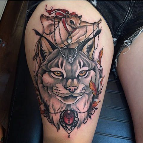 Tattooed lynx on a girl's thigh