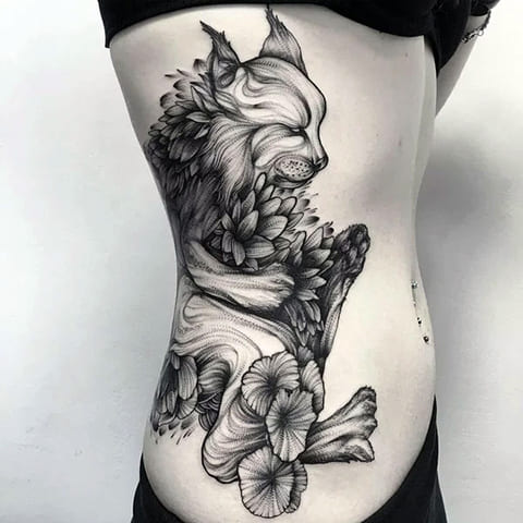 Tattoo lynx on a girl's side