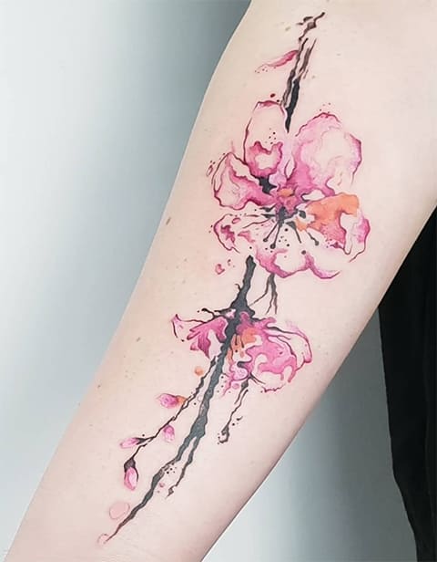 Tattoo with Cherry Blossoms on a girl's arm