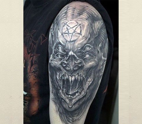 Tattoo with a demon on his shoulder