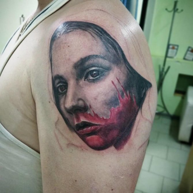 Tattoo of a girl in blood on the shoulder