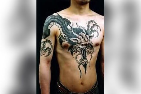 Tattoo with a dragon on his chest