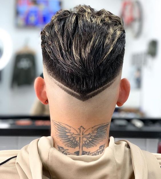 Tattoo with wings on his neck