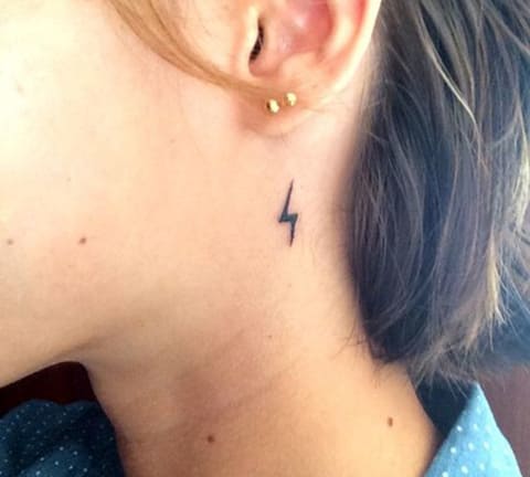 Tattoo with a small lightning bolt on the neck
