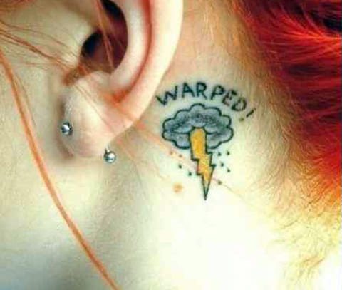 Tattoo with a lightning bolt on the neck behind the ear