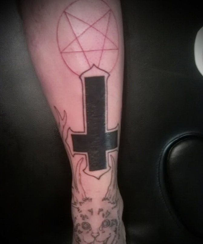 Tattoo with inverted cross.