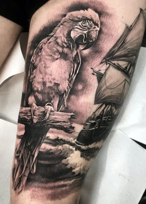 Tattoo of a parrot on his leg