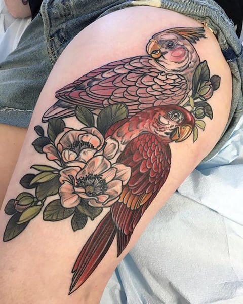 Tattoo of a parrot on his thigh