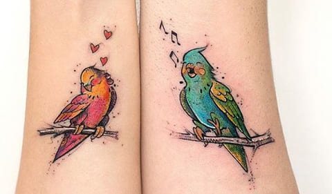 Tattoo of parrots on wrist