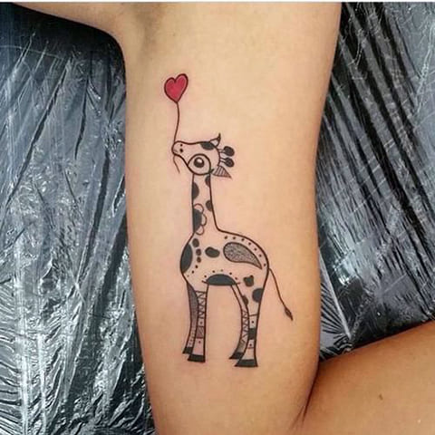 Tattoo with a giraffe on his arm