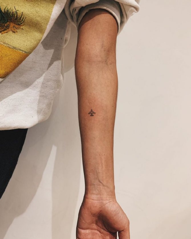 airplane tattoo on wrist