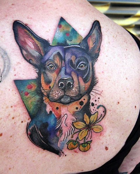 Tattoo dog on his shoulder blade