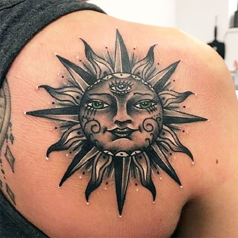 Tattoo sun on his scapula