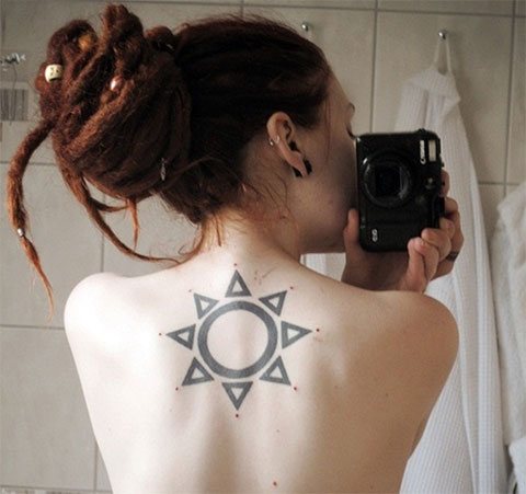 Tattoo the sun on a girl's back