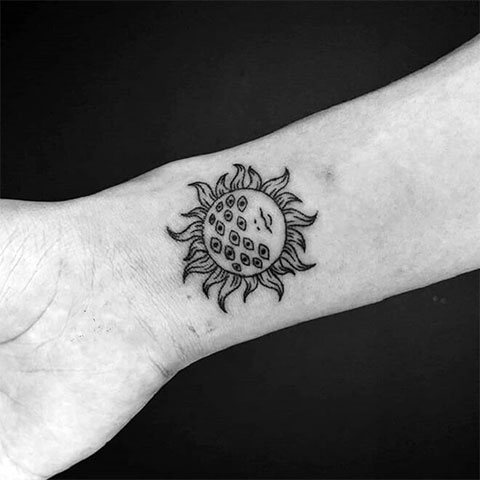 Tattoo sun on the wrist