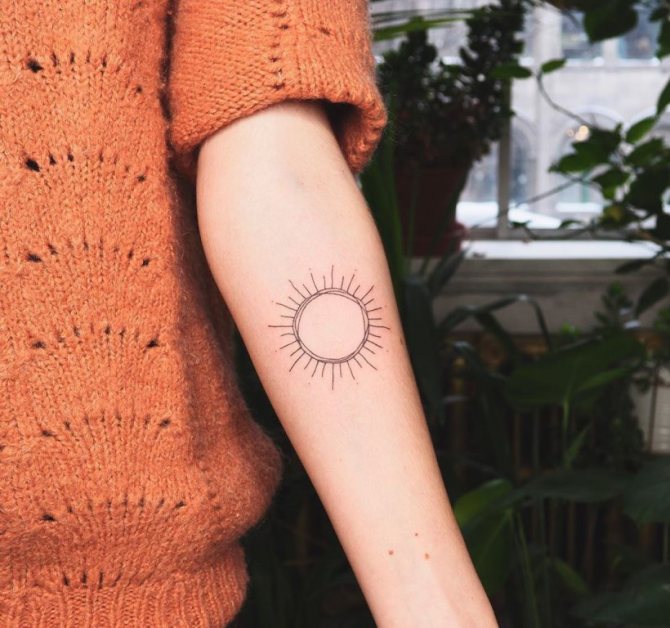 sun tattoo on the wrist