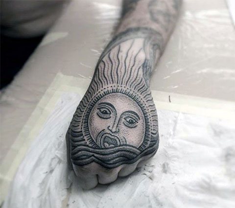 Tattoo sun on wrist