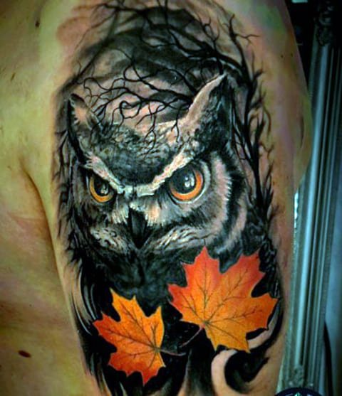 Tattoo of an owl on a man's shoulder