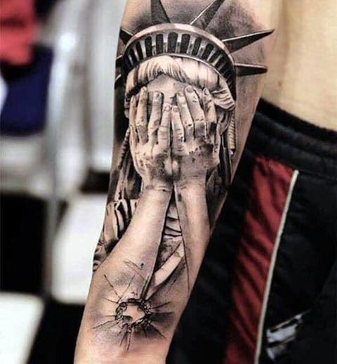 Statue of Liberty tattoo with his eyes closed