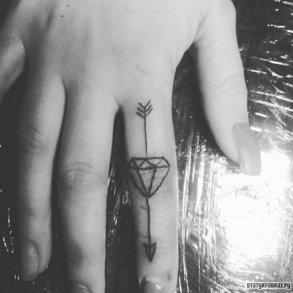 Tattoo arrow with a diamond on your finger