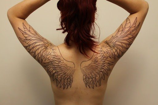 Tattoo thin wings on his back
