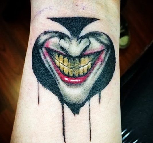Tattoo Joker's Smile on his hand. Sketches, photo