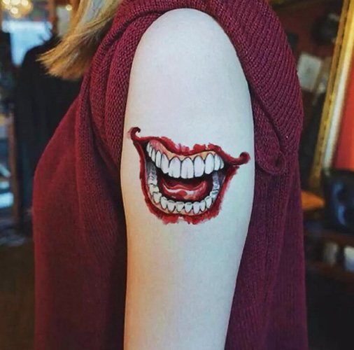 Tattoo Joker Smile on his arm. Sketches, photo