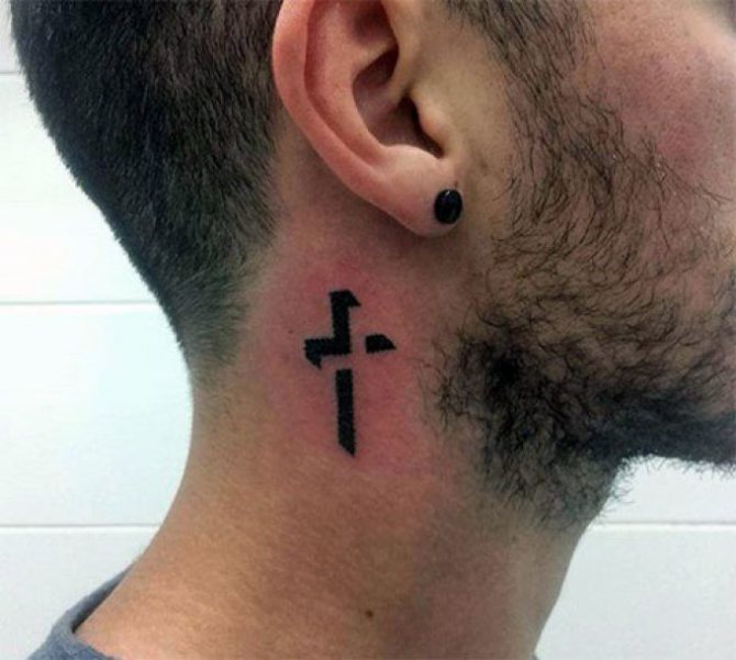 Tattoo in the shape of a cross - the epitome of minimalism