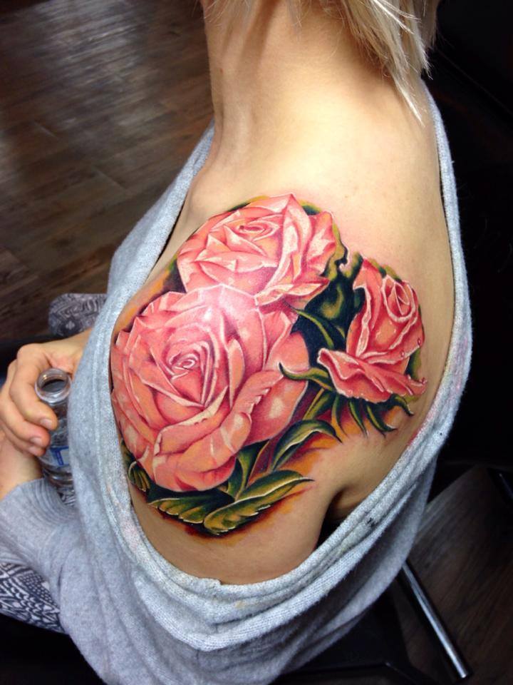 Tattoo of a rose on a woman's shoulder